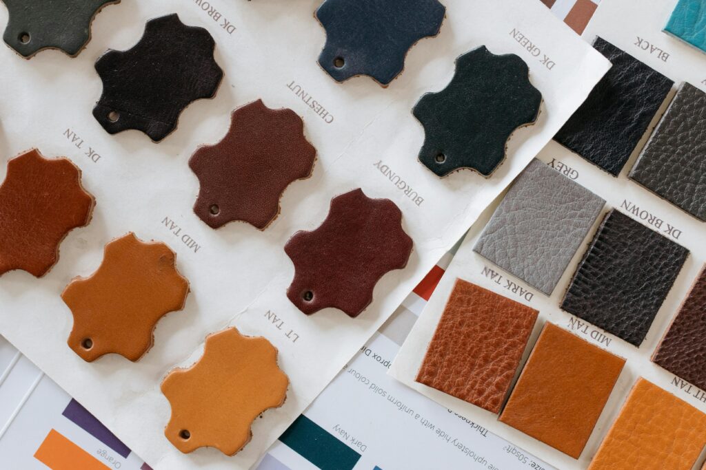 pexels-photo-6648440-6648440 Selection of leather swatches in various colors and textures displayed on paper samples.